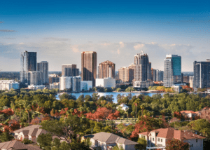 Orlando skyline with suburban homes representing local estate sales market.